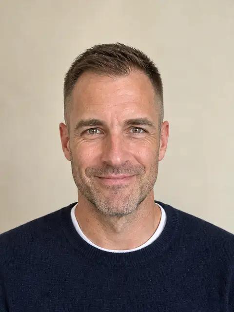 The same man with a crew cut, longer on top