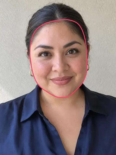 A woman with a round face, its outline drawn on her face