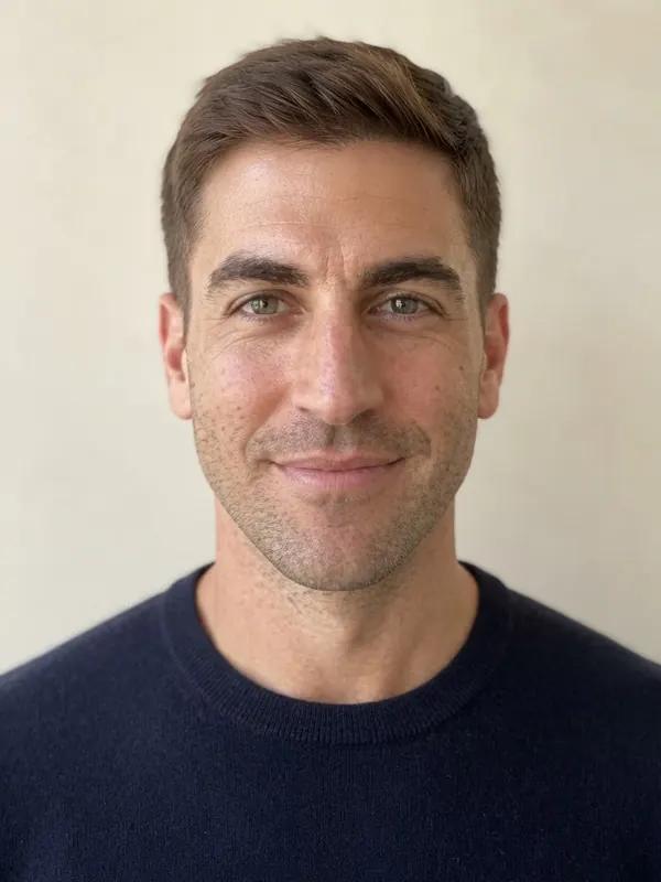 A man in his thirties with a diamond face and short hair