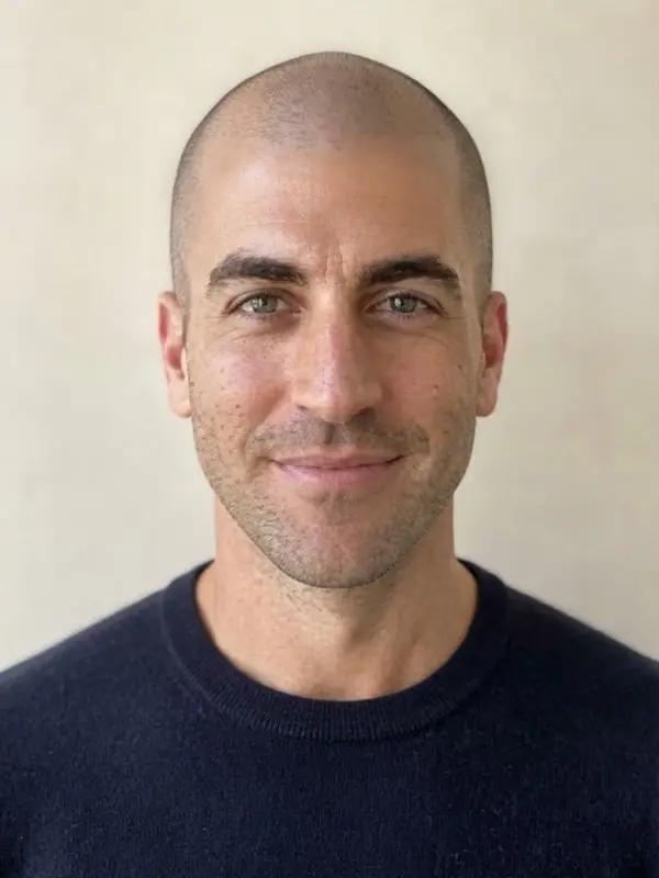 The same man with a shaved head