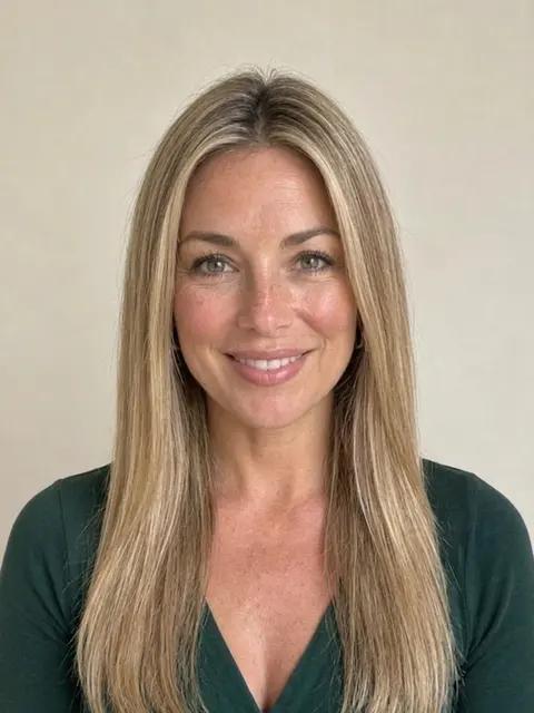 A woman with long straight honey blonde hair