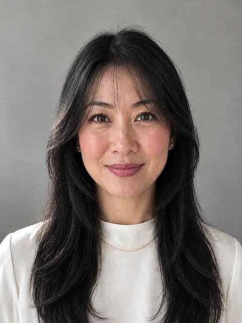 A woman in her forties with a hush cut
