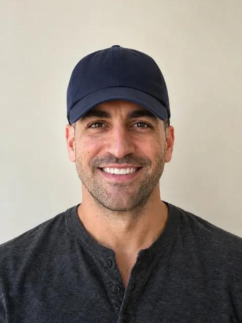 The same man in a baseball cap that hides his hair and forehead