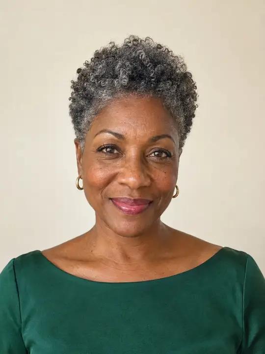 A Black woman in her fifties with a short silver tapered natural cut