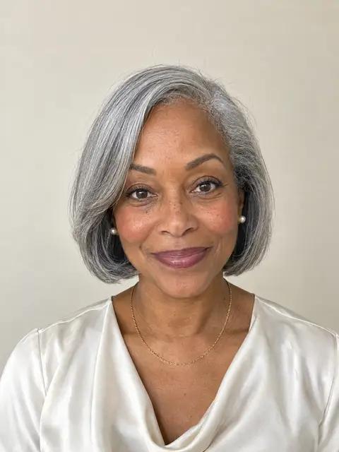 A Black woman in her sixties with a chin-length silver-gray bob