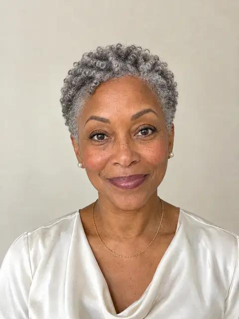 A Black woman in her sixties with a silver tapered natural cut