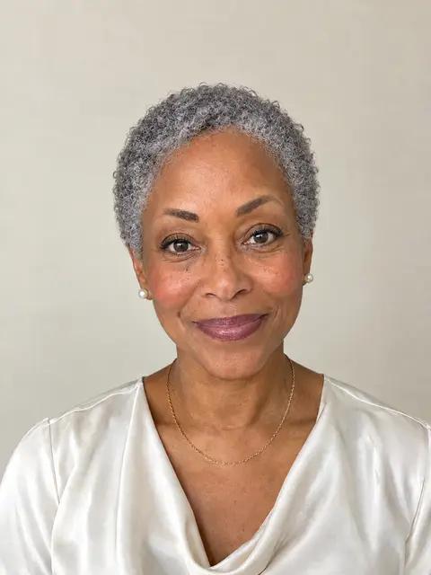 A Black woman in her sixties with a short silver TWA